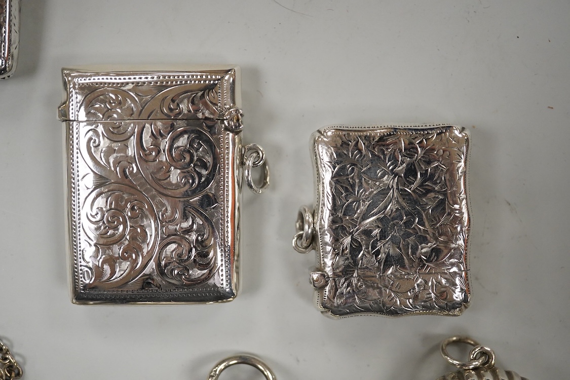 Two late Victorian silver twin compartment sovereign cases, Birmingham, 1891 & 1896, both approx. 57mm, a gold plated sovereign case, together with three silver vesta cases, a silver purse and a silver mounted notebook.